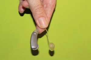 Hand holding a hearing aid