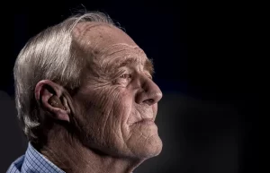 Older man with hearing aid