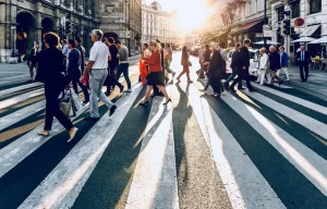 People in a busy city crossing the street on a crosswalk