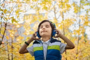 Little boy outside with headphones on