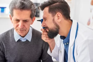 Audiologist examining a patient's ear