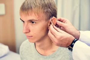 Teenager getting fitted for a hearing aid