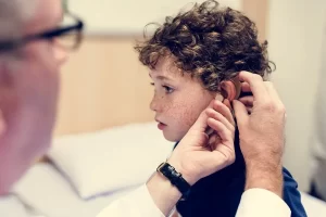 Young boy getting fitted for a hearing aid