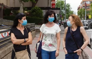 Women wearing masks walking down the street