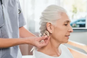 Older woman getting fitted for a hearing aid