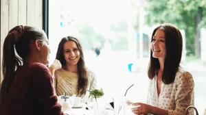 3 woman enjoying their conversation at a cafe