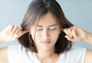Woman plugging her ears