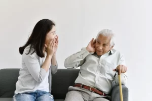 Woman shouting at her father so he can hear her