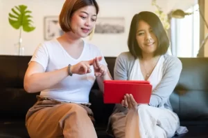 Two women learning how to sign