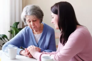 Woman talking with her mother about hearing loss