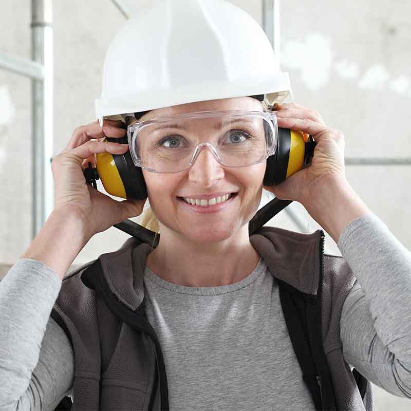 Woman wearing ear protection to drown out background noises at work