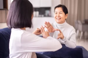 Adult women signing to each other